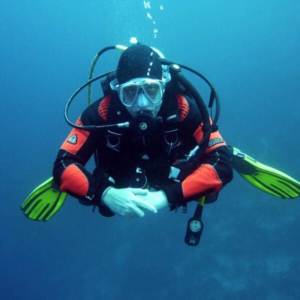 Diver underwater in full scuba gear.