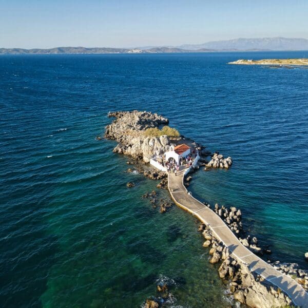 Aerial view of rocky coastline with small white building