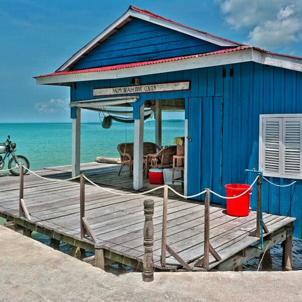 Blue seaside shack with motorcycle, Palm Beach Dive Center.