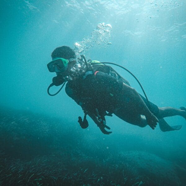 Scuba diver exploring underwater with clear visibility.
