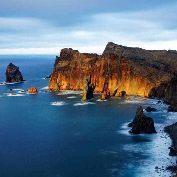 Dramatic coastal cliffs over serene blue ocean