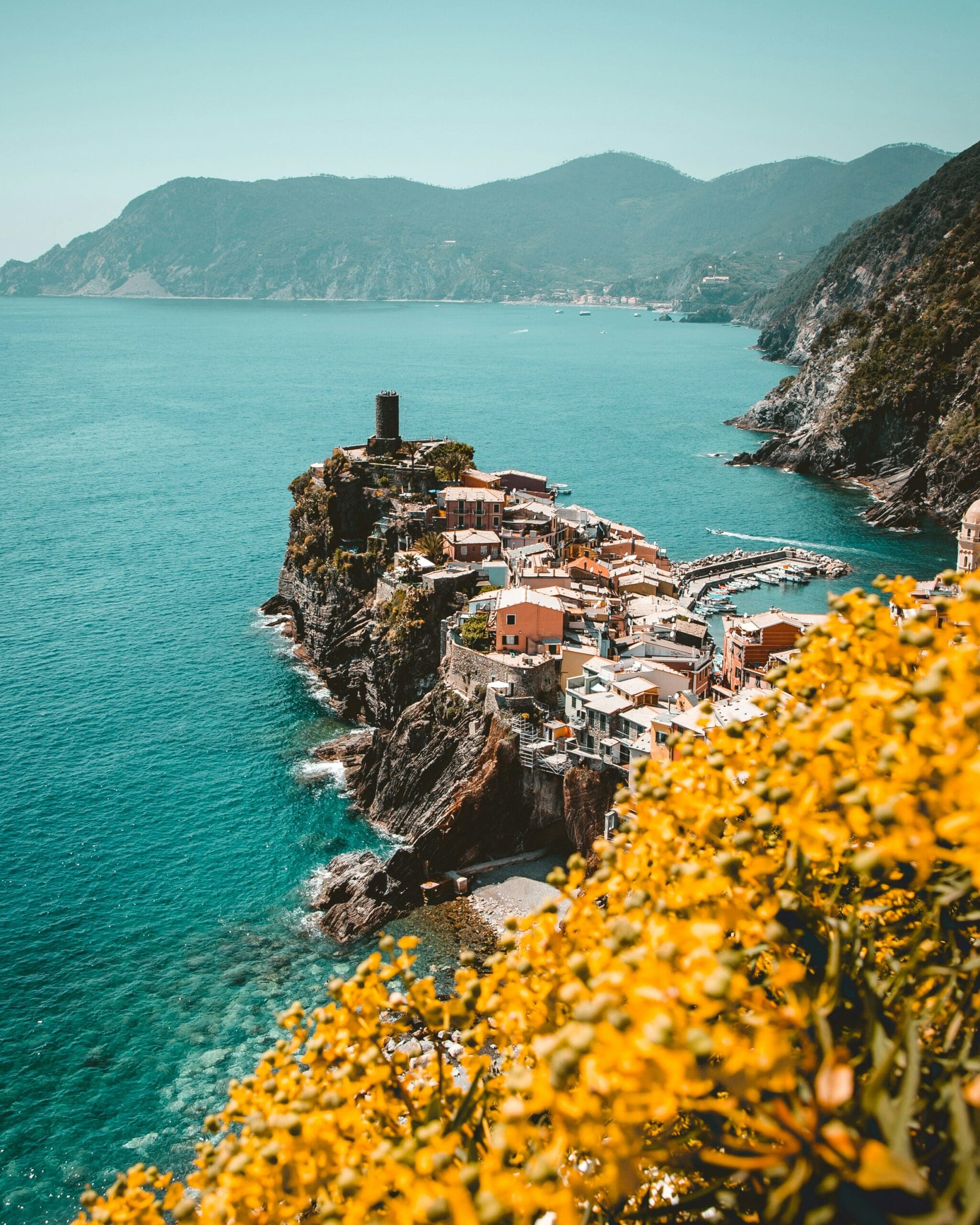 Coastal village perched on cliff by blue sea