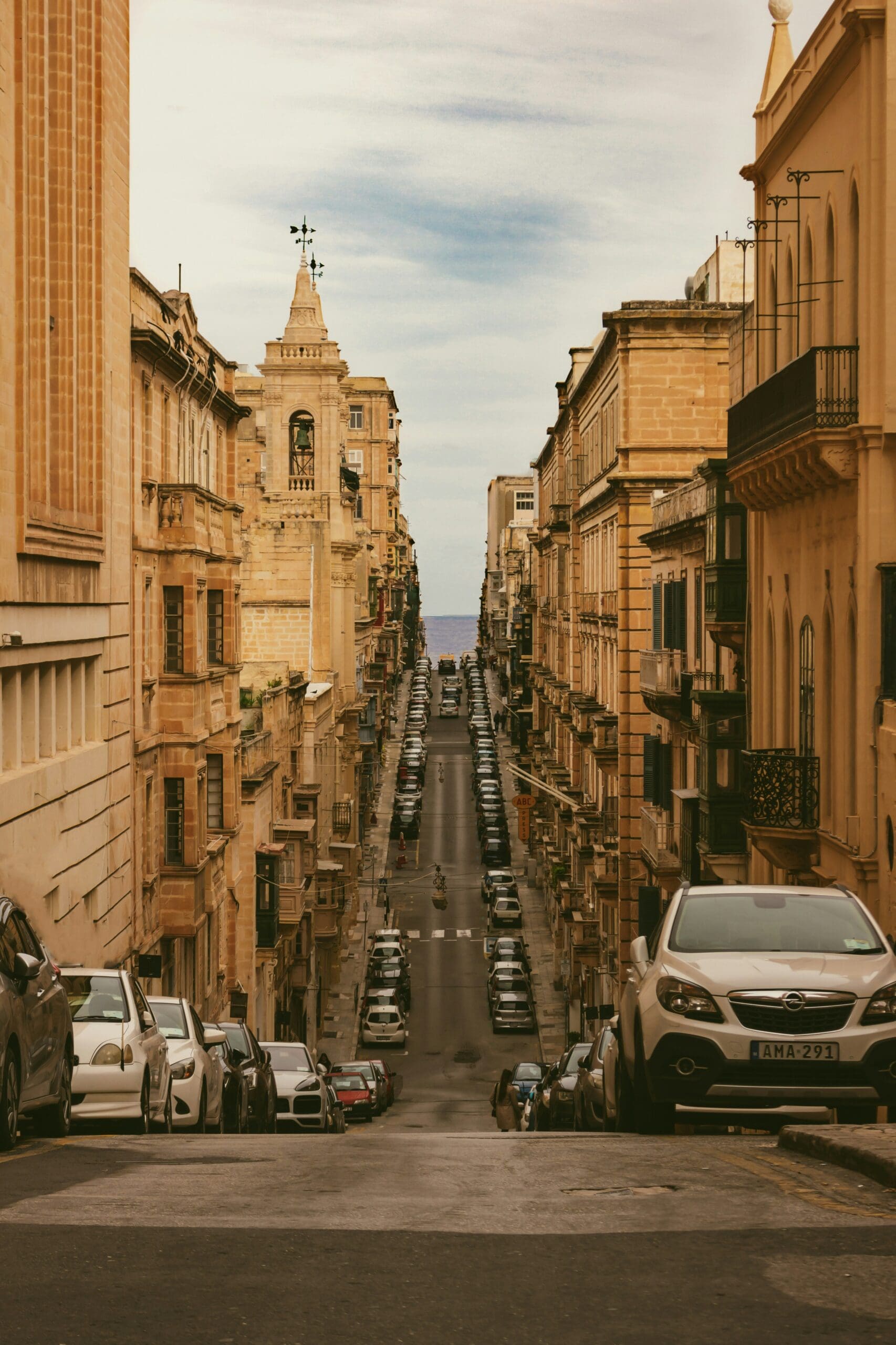 Historic street view with cars and buildings in Malta