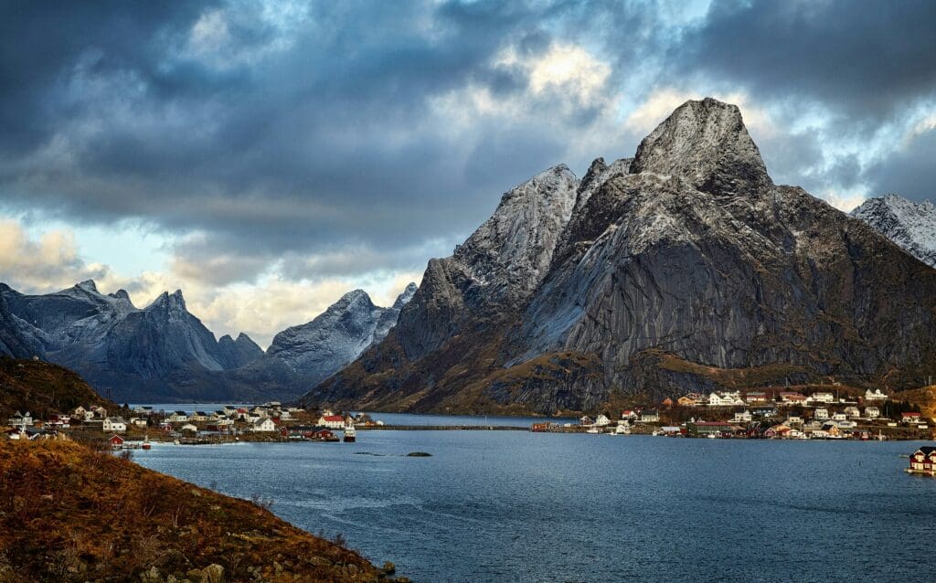 Snowy mountain peaks overlooking a scenic waterfront village