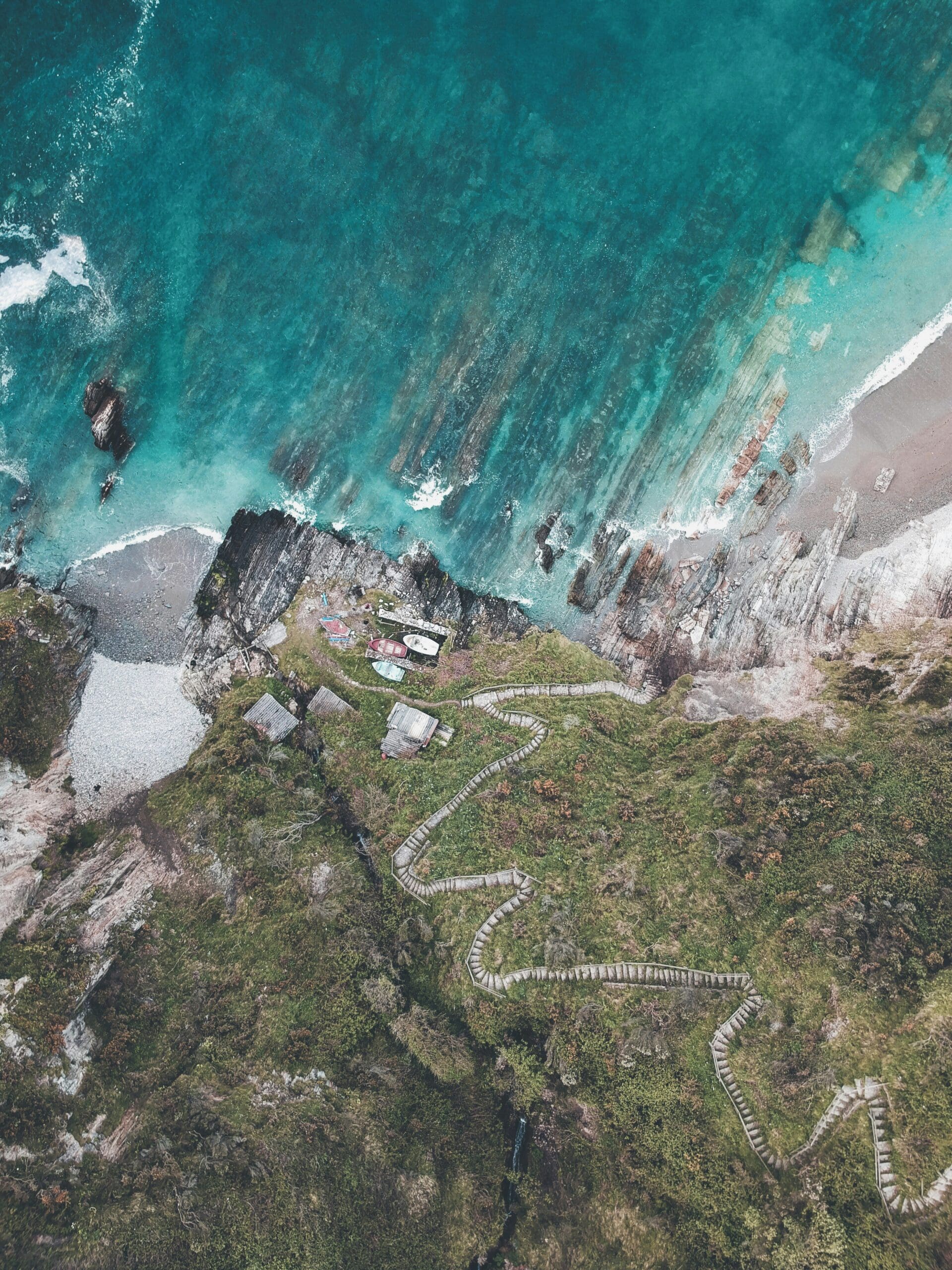 Aerial view of coastal trail and clear turquoise water