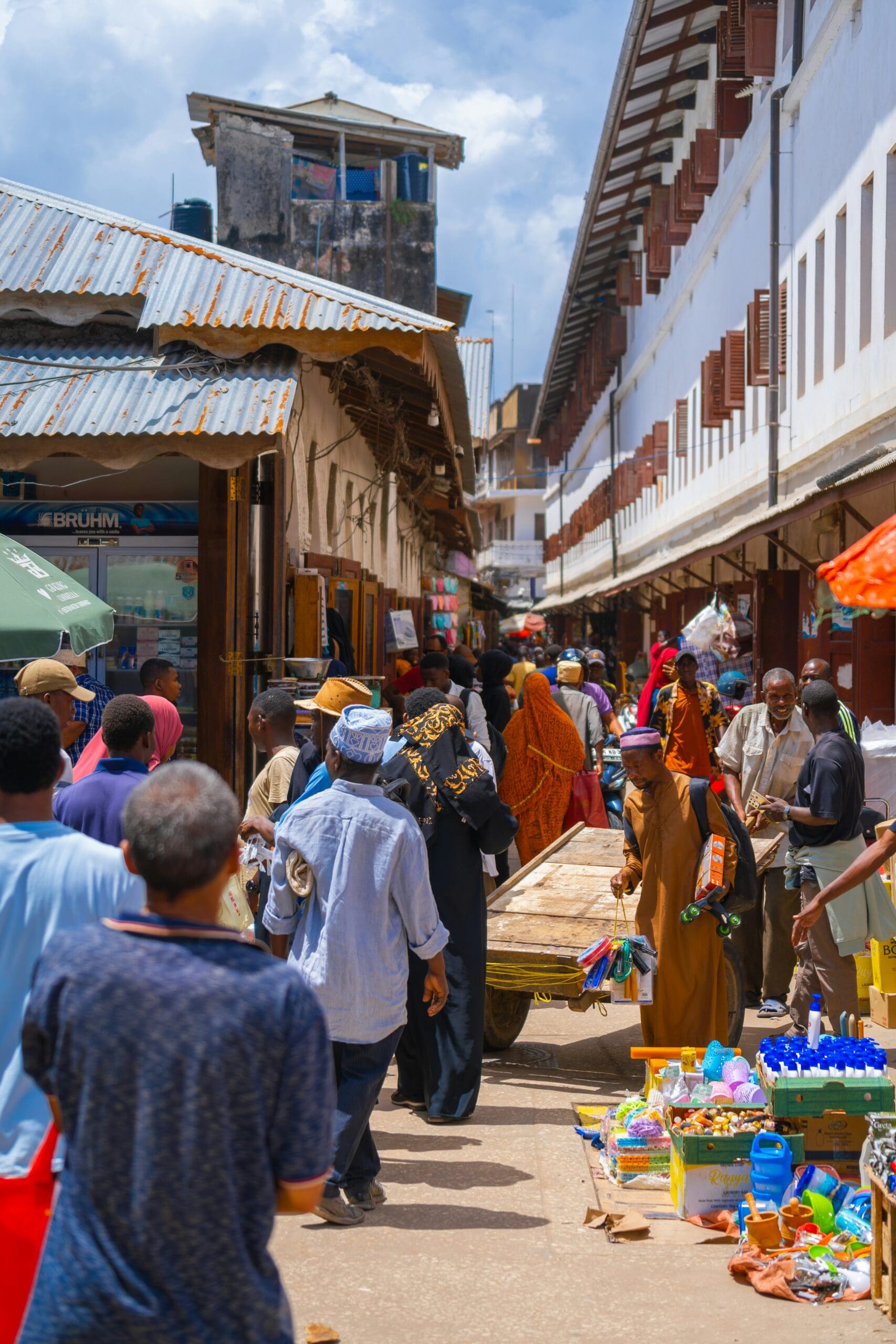 Bustling street market with diverse crowd and colorful goods