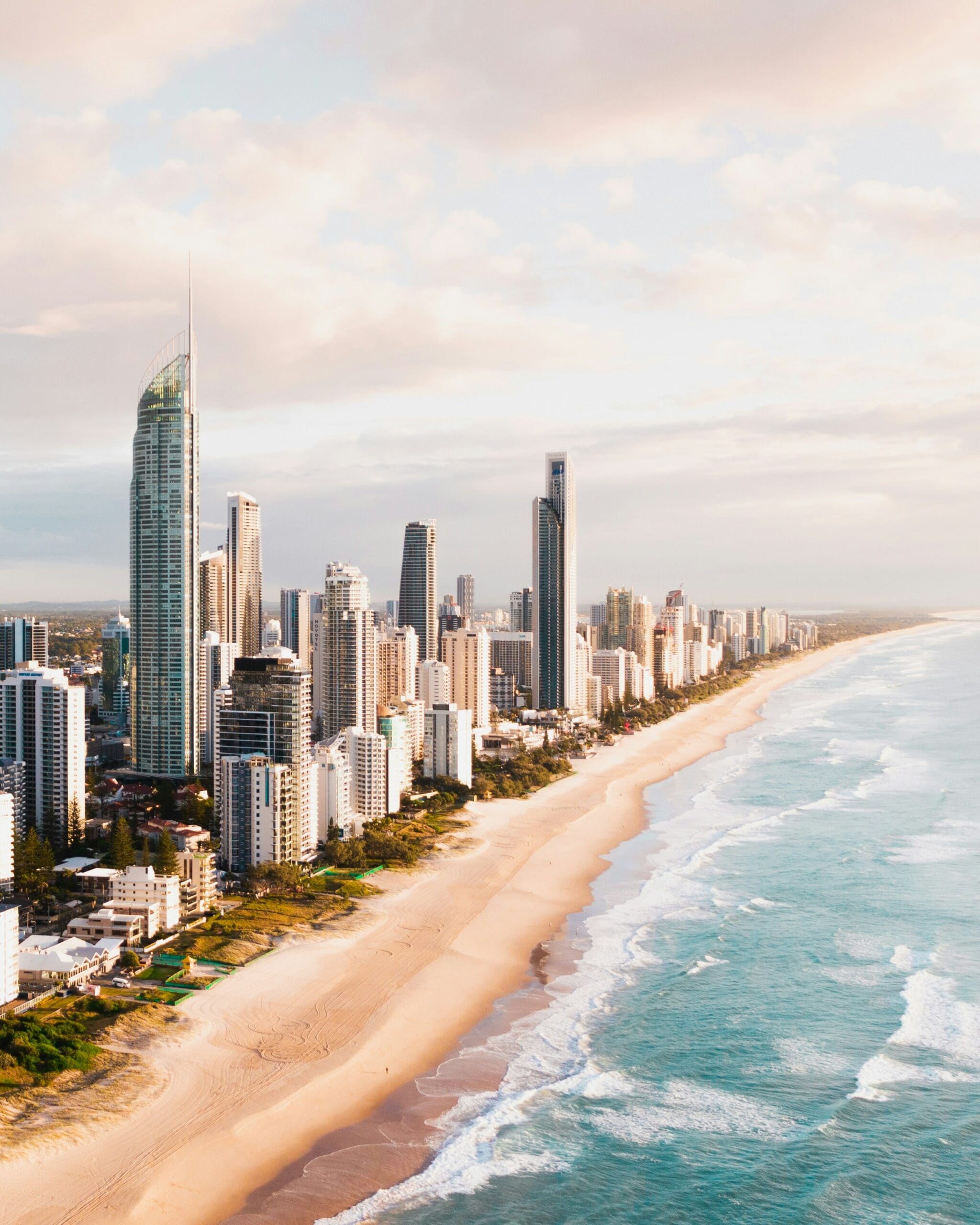 Aerial view of sunny coastal city skyline and beach