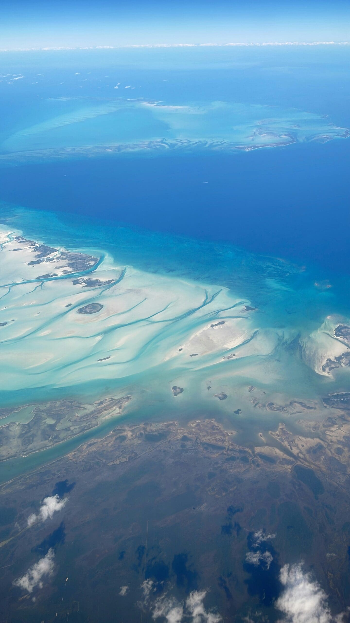 Aerial view of vibrant turquoise ocean and islands