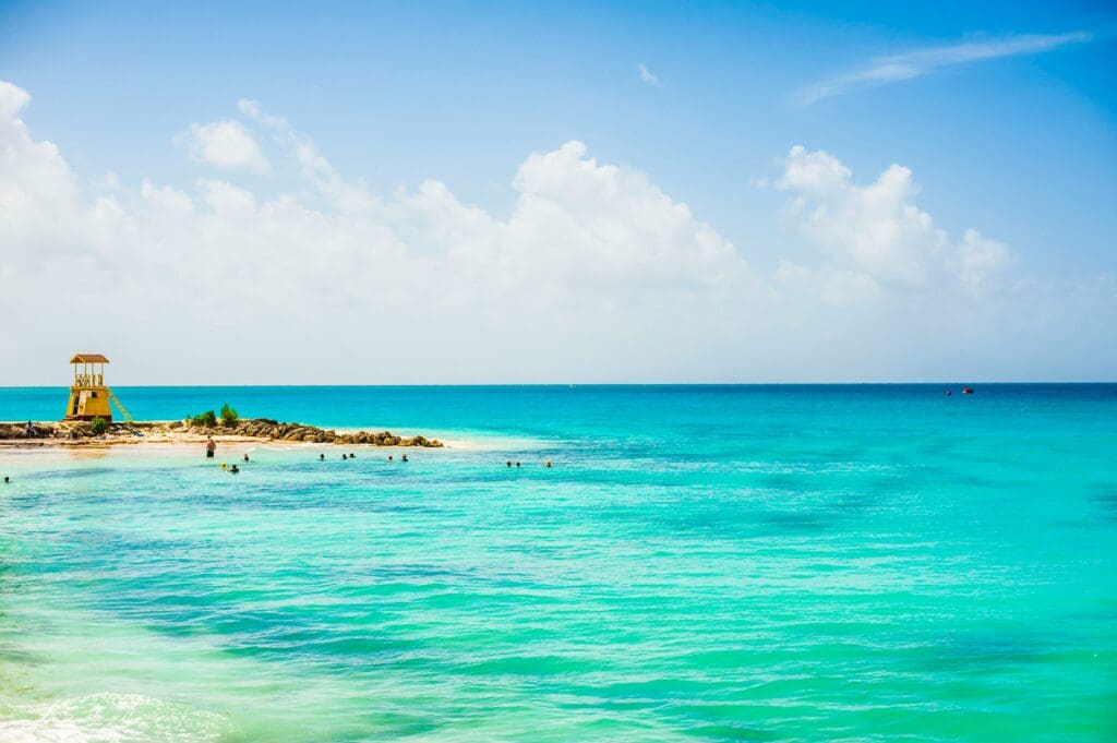Tropical beach with blue water and lifeguard tower