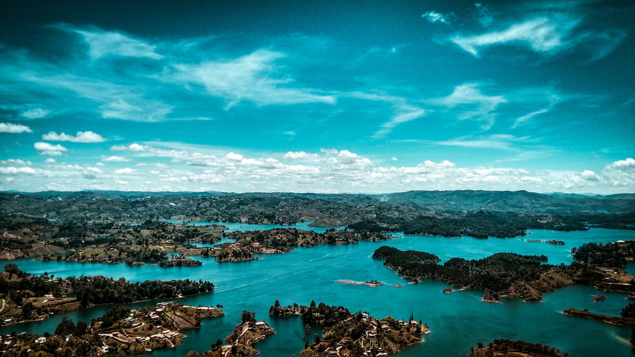 Aerial view of vibrant blue lakes and lush hills