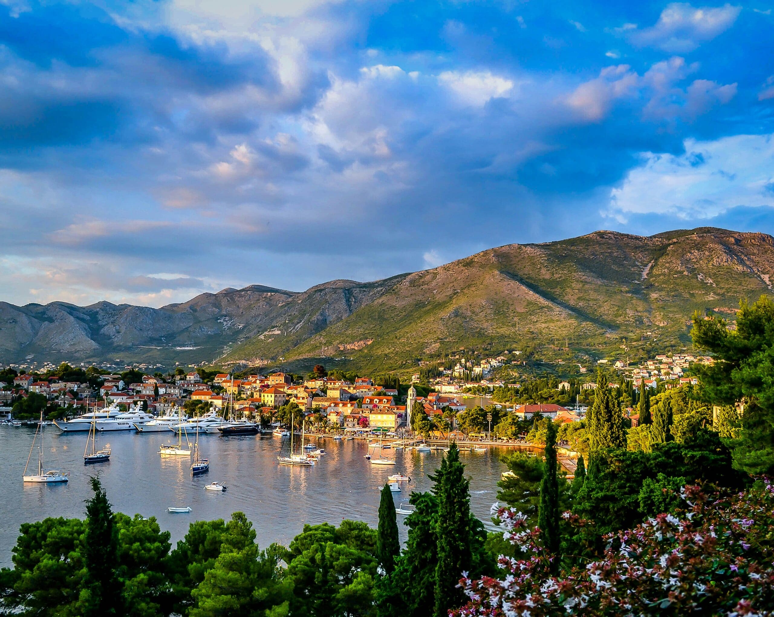 Scenic coastal town nestled between lush mountains at sunset