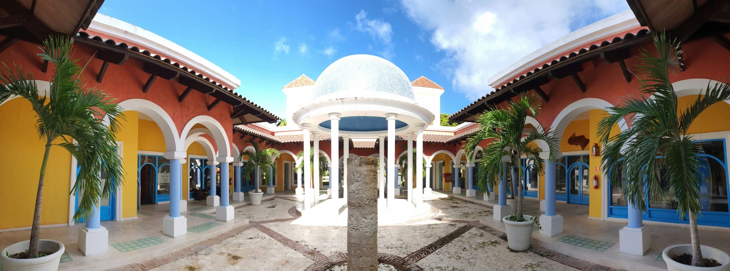 Bright courtyard with arches and tropical plants