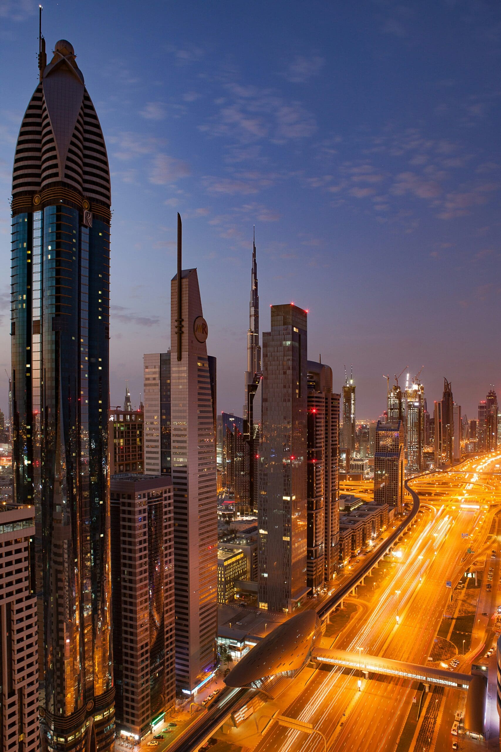 Dubai skyline with illuminated skyscrapers at twilight