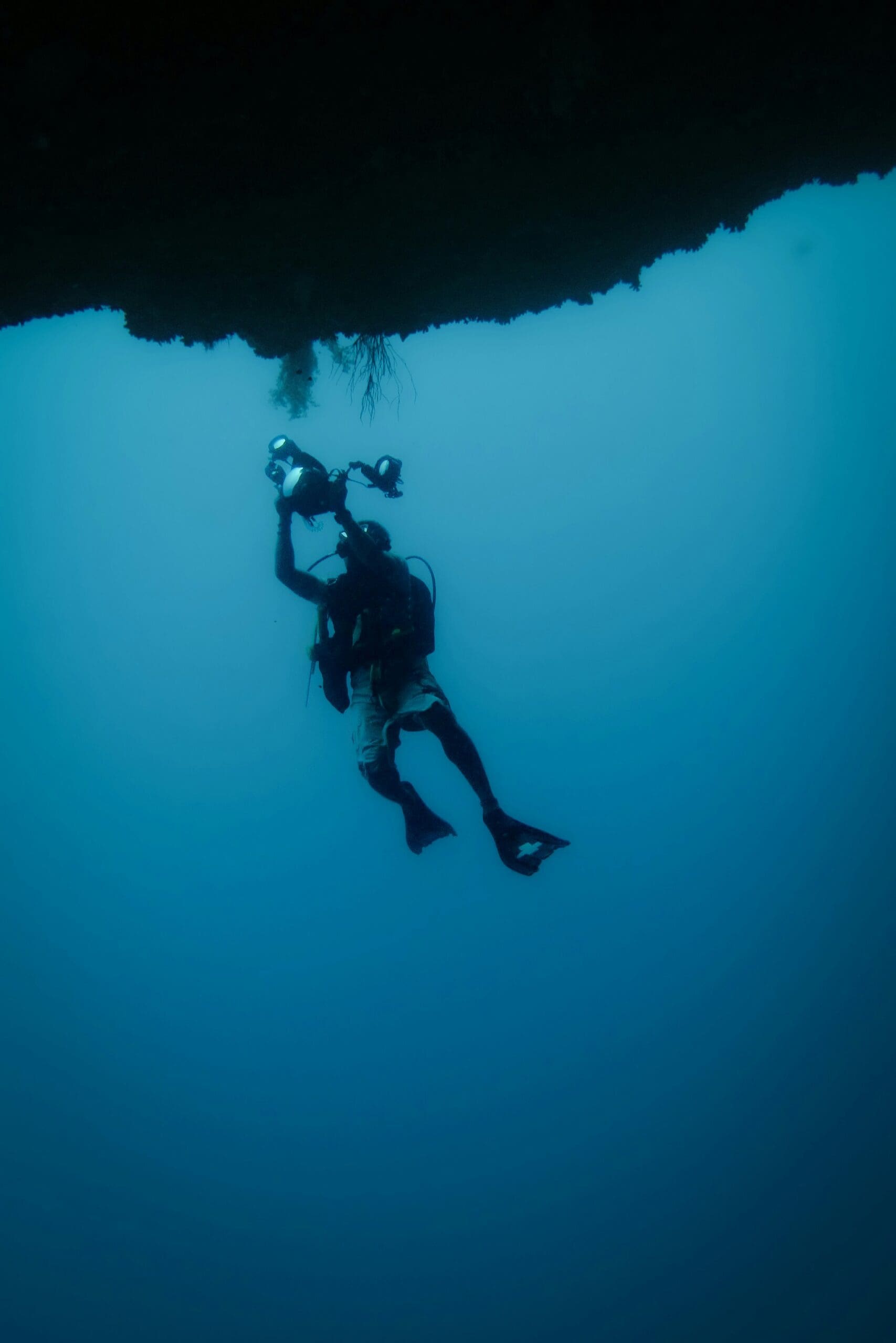 Diver exploring underwater with flashlight