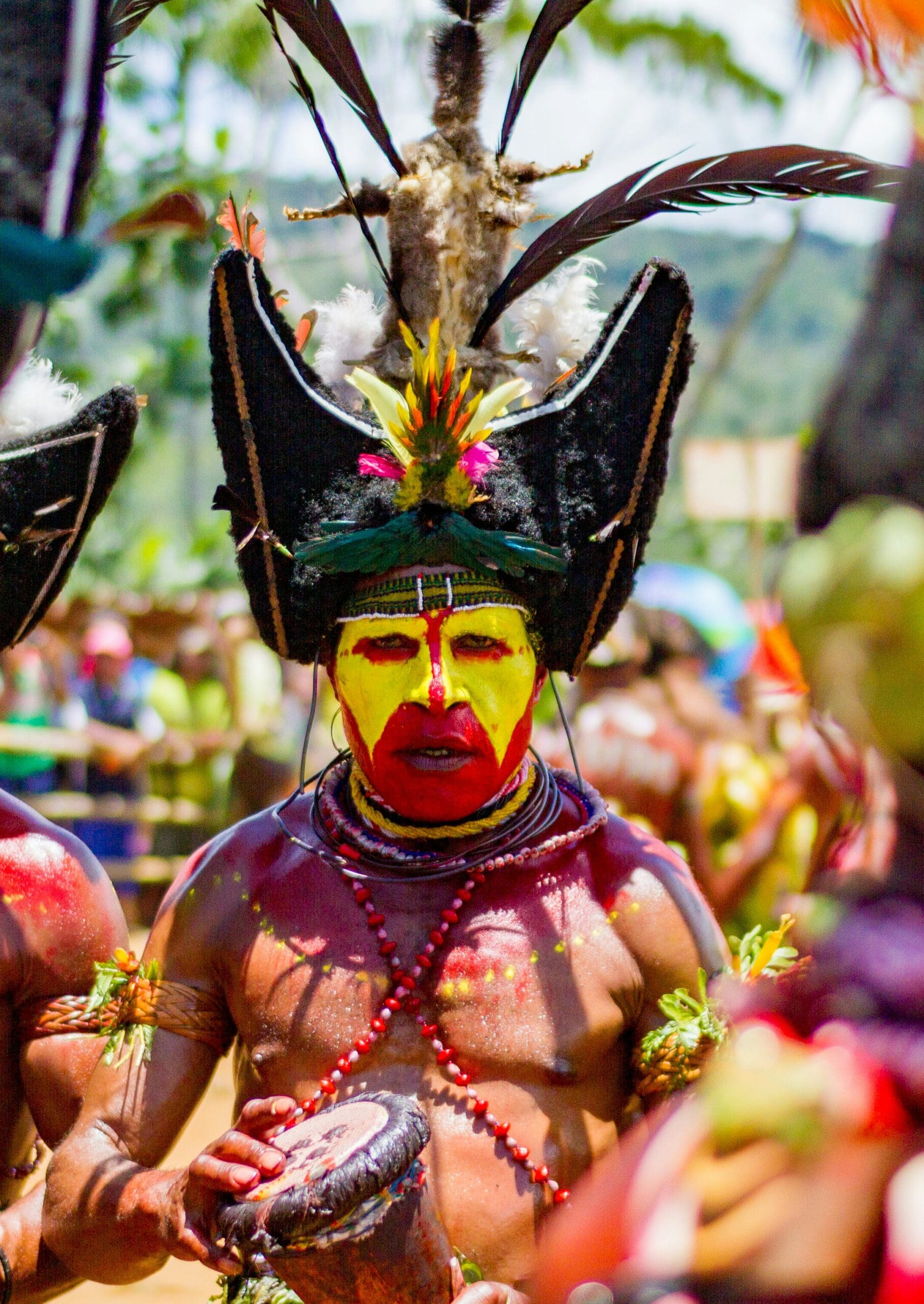 Man in traditional tribal costume with colorful face paint