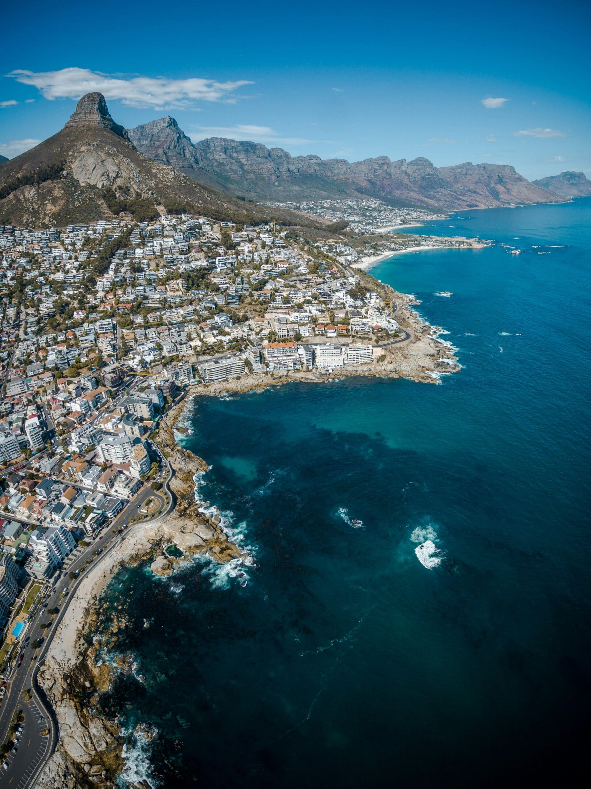 Aerial view of coastal city with mountain backdrop