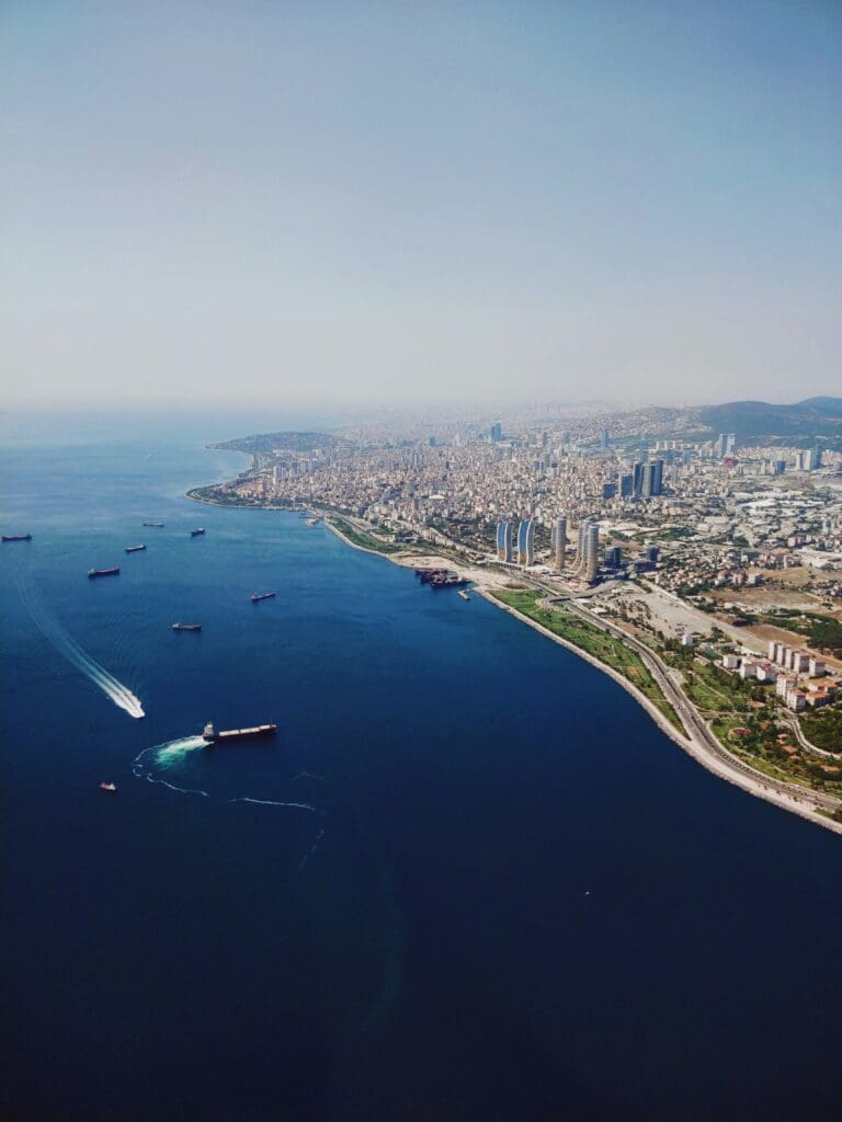 Aerial view of coastal city with ships and clear waters