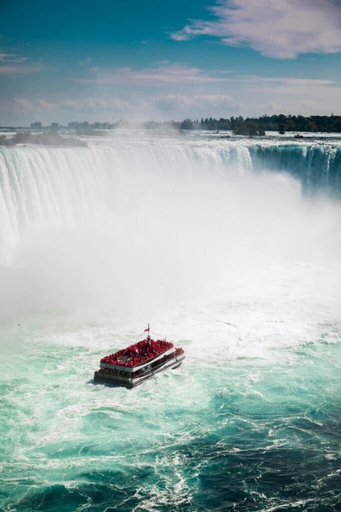 Tourist boat near misty Niagara Falls